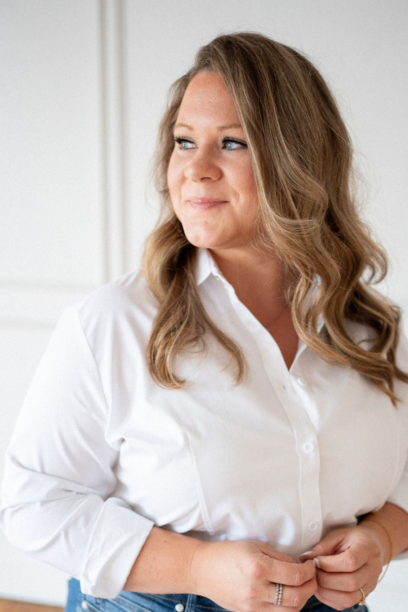 Woman wearing a white shirt against a plain background